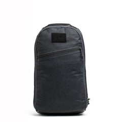 Black waxed canvas GORUCK backpack with single laptop compartment and diagonal front zipper pocket