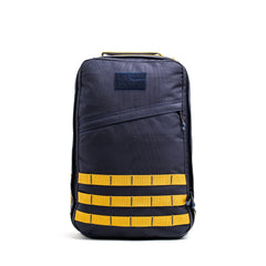 The GR1 USA - Cordura is a navy blue Special Forces backpack with yellow horizontal straps and a top handle, displayed on a white background.