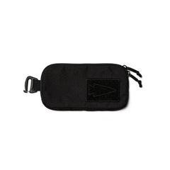 Black GORUCK sternum strap pouch with arrow logo, dual zippered compartments, and clip attachment