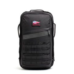 The Rucker - Long Range is a black backpack featuring an American flag patch, front handle, and lower front webbing—ideal as a comfortable rucksack for distance rucking or intense rucking events.