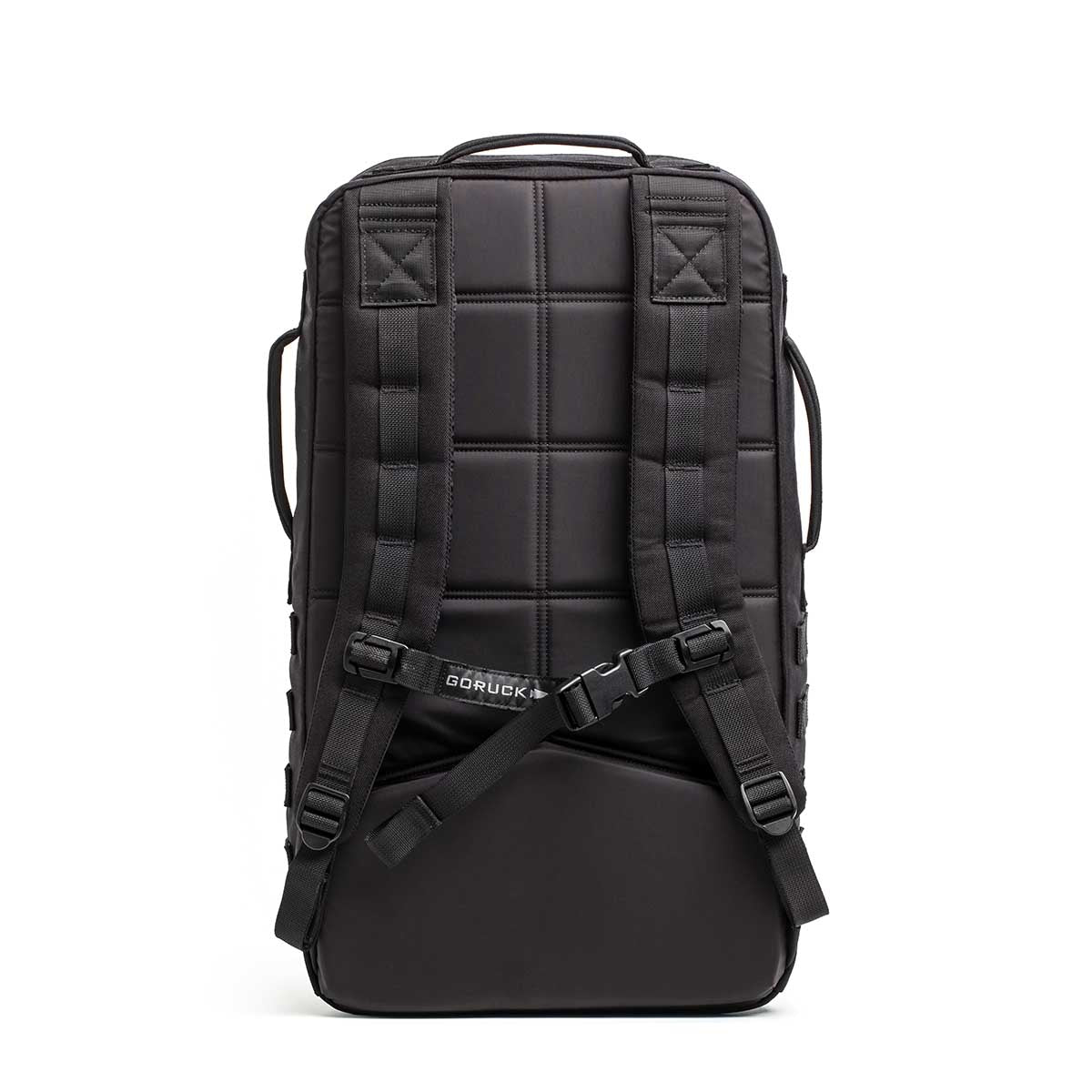 The Rucker - Long Range is a black backpack shown from the back, featuring padded shoulder straps and a sternum strap—built for distance rucking or events, and stands upright for easy access.