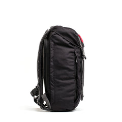 Side view of a black GORUCK tactical rucking backpack with padded straps and multiple compartments