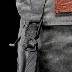 Closeup of GORUCK slate gray rucksack buckle and strap with leather logo patch