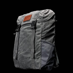 GORUCK slate gray rucksack with leather patch and front buckles on black background