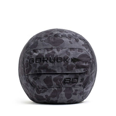 The Sand Medicine Ball in black camo features "GORUCK," an arrow logo, and "80" embroidery—ideal for enhancing core stability in your home gym.