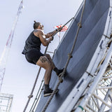 Man wearing GORUCK Ranger Panties climbs obstacle rope wall at outdoor rucking event