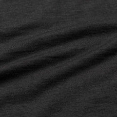 Close-up of black and charcoal merino wool short sleeve shirt fabric texture