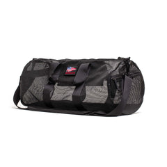 The Mesh Gym Bag features a shoulder strap, mesh panels for ventilation, and a small American flag patch on the front.