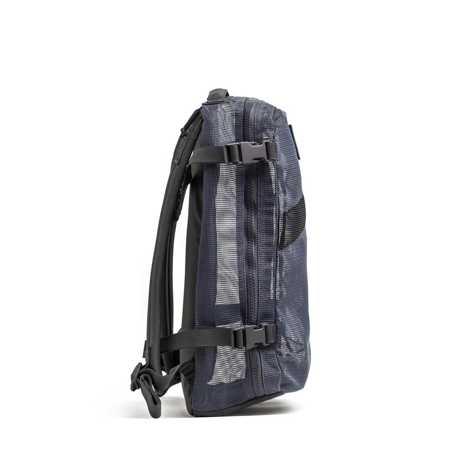 The Mesh Ruck backpack in dark gray is shown from the side, featuring black straps and buckle closures.