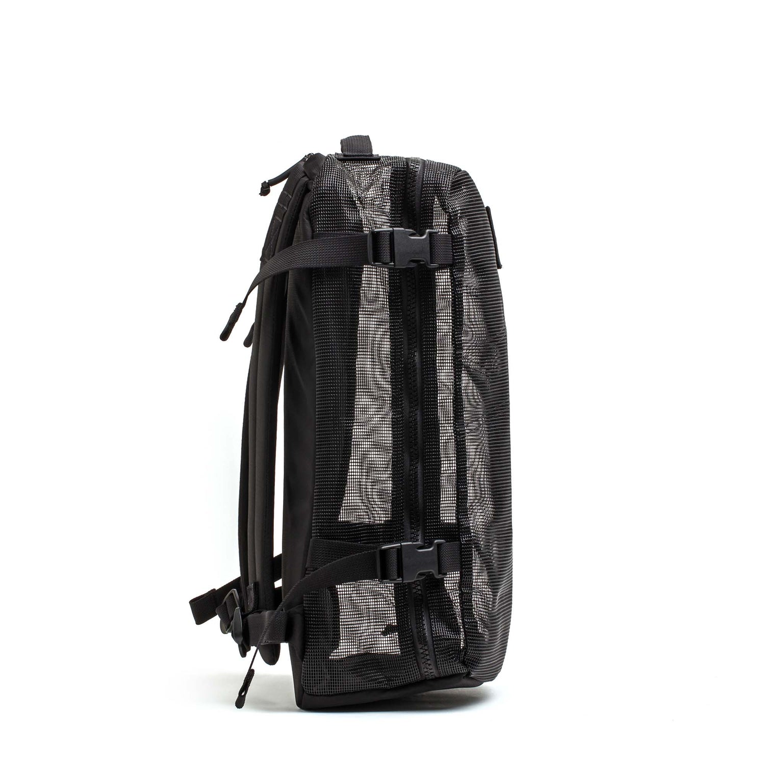 The Mesh Ruck, a black mesh backpack with two front buckles and side straps on a white background, is ideal as a quick-drying beach bag.