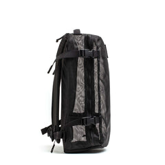 Side view of a black GORUCK Mesh Ruck backpack with adjustable straps and breathable mesh design