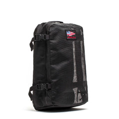 Black GORUCK mesh rucksack with American flag logo patch, side compression straps, and reflective details