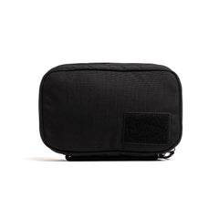 The GR1 Field Pocket - USA is a small, rectangular black pouch with a front patch, ideal for organizing electronics, shown against a white background.