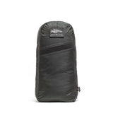 A dark gray Packable Bullet Ruck - Ripstop ROBIC® backpack stands upright, featuring a small front patch, AquaGuard zippers, and a side zipper.