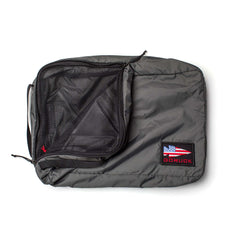 The GORUCK Packing Cubes, made from durable 200D nylon in gray, feature a mesh zip pocket and a US flag patch with “GORUCK” in red—perfect for keeping your essentials organized while traveling.