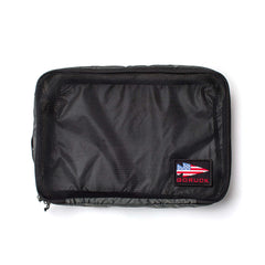 Packing Cubes are black zippered organizers made from durable 200D nylon with a mesh front for easy visibility, plus a GORUCK patch featuring an American flag and red spearhead—ideal for keeping your travel items organized.