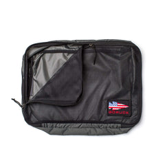 The Packing Cubes are black mesh cubes with zippers, crafted from durable 200D nylon and feature a GORUCK patch with an American flag—ideal for organizing your travel essentials.