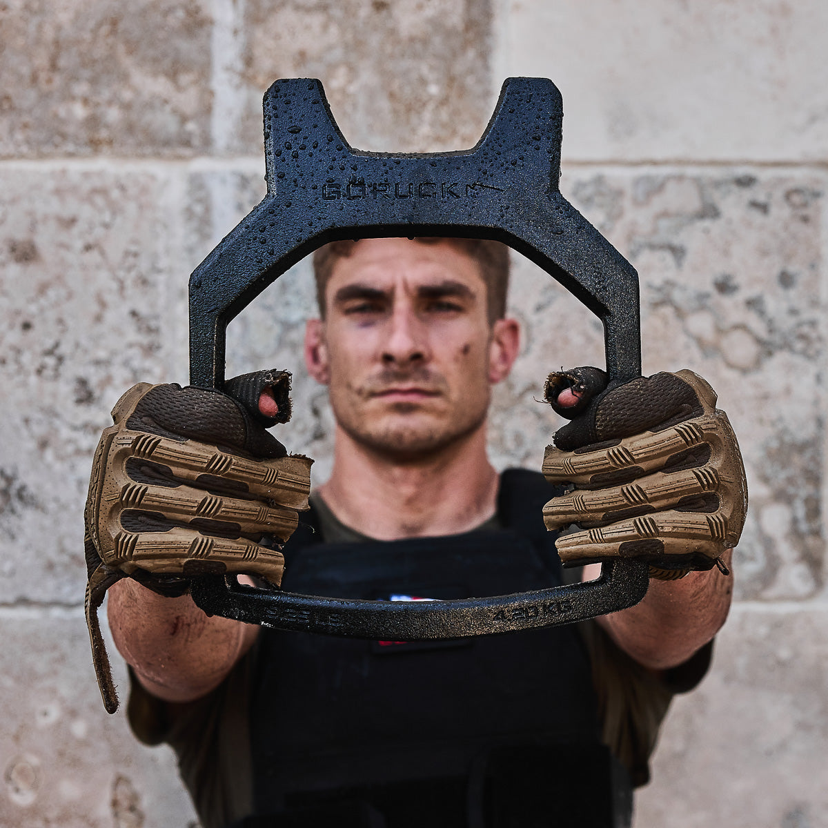 A man wearing tactical gloves holds a Curved Ruck Plate, labeled 