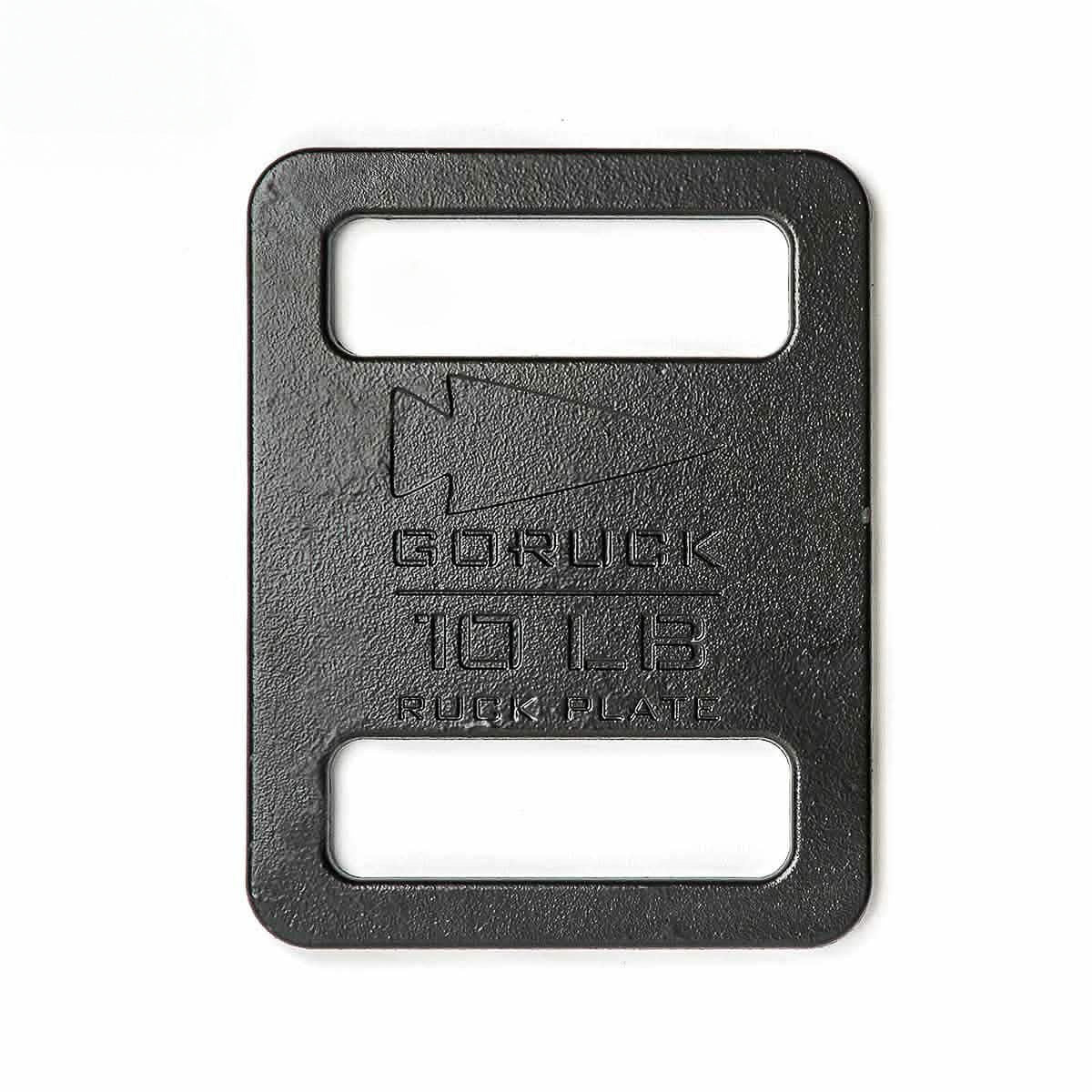 The Ruck Plates are rectangular black metal weights engraved with "GORUCK 10 LB RUCK PLATE," designed to fit perfectly in your Rucker for efficient weighted training.