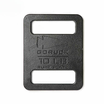 The Ruck Plates are rectangular black metal weights engraved with "GORUCK 10 LB RUCK PLATE," designed to fit perfectly in your Rucker for efficient weighted training.