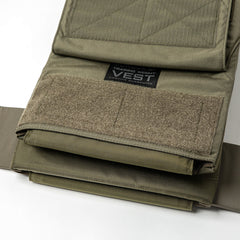 Close-up of the Training Weight Vest 2.0 in olive green, featuring Velcro straps, visible ruck plates, and a label.