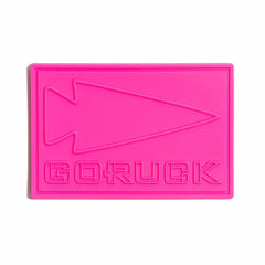Hot pink rectangular PVC patch with embossed GORUCK logo and arrowhead design