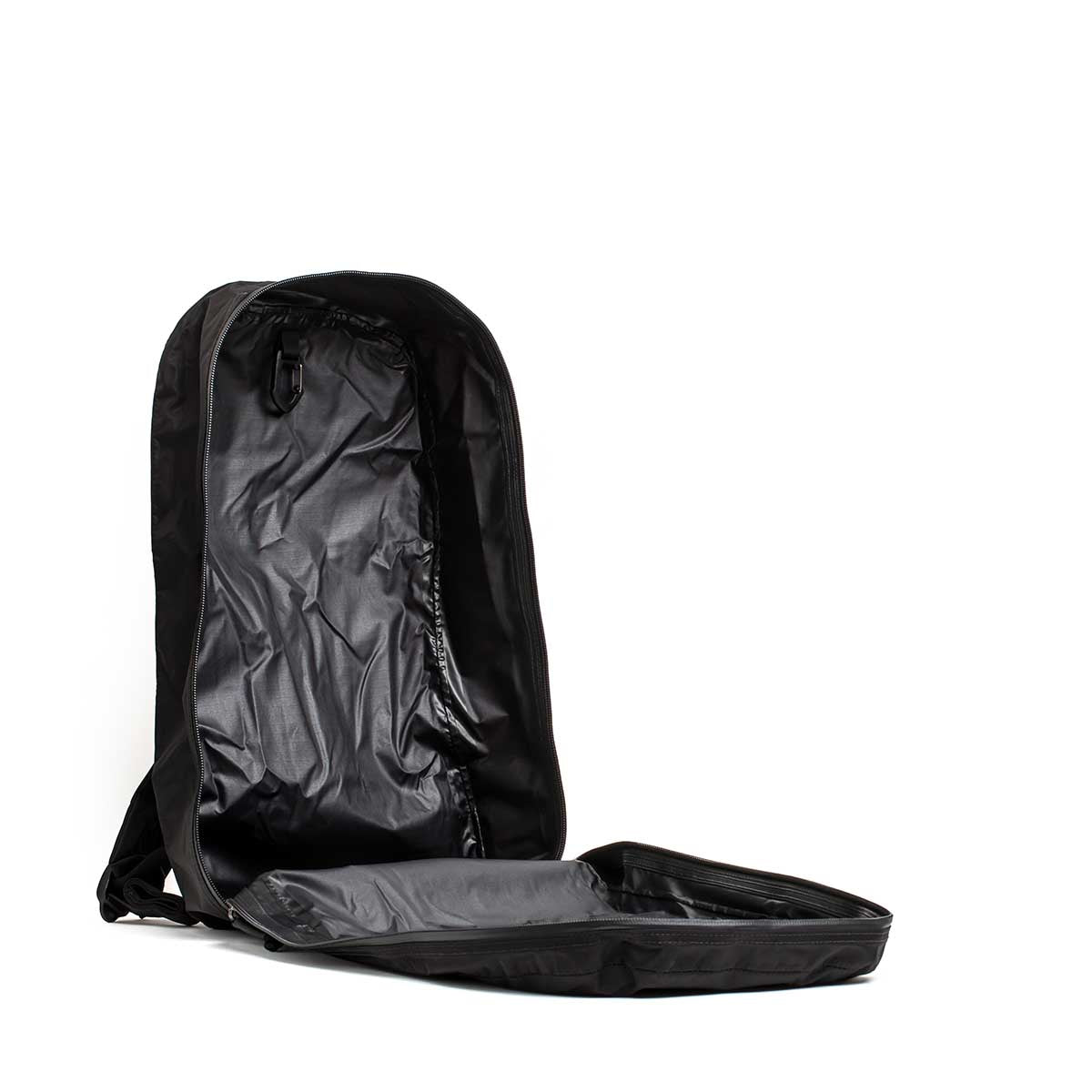 The Packable Bullet Ruck - Ripstop ROBIC® is shown lying on its back, lightweight and empty, with its main compartment unzipped and fully open.