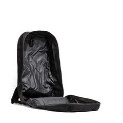 The Packable Bullet Ruck - Ripstop ROBIC® is shown lying on its back, lightweight and empty, with its main compartment unzipped and fully open.