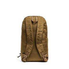 The Packable Bullet Ruck - Ripstop ROBIC® is a brown lightweight travel backpack shown from the back, featuring padded shoulder straps and a top handle.