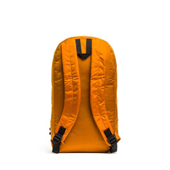 The Packable Bullet Ruck - Ripstop ROBIC® is an orange lightweight travel backpack with black buckle straps, displayed from the back on a white background.