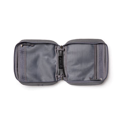 The GR2 Field Pocket is an open, gray travel pouch made from durable 1000D Cordura, featuring mesh compartments and zippers on each side.