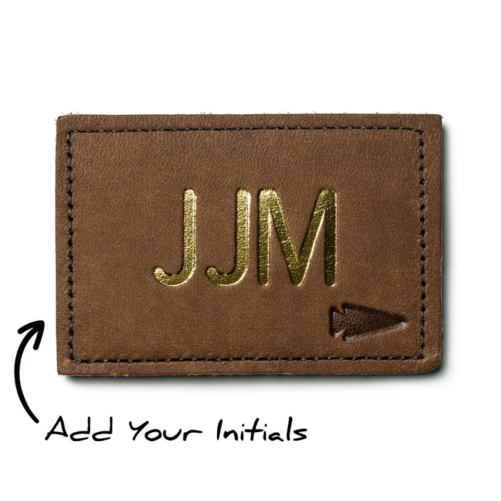 The Patch - Custom Leather Monogram showcases gold initials "JJM" with an arrow, plus the text "Add Your Initials" for personalization.