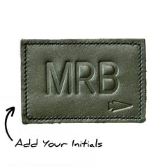 The Patch - Custom Leather Monogram features a green leather design embossed with "MRB" and a small arrow. Personalize it by adding your initials for a unique, custom leather patch tailored just for you.
