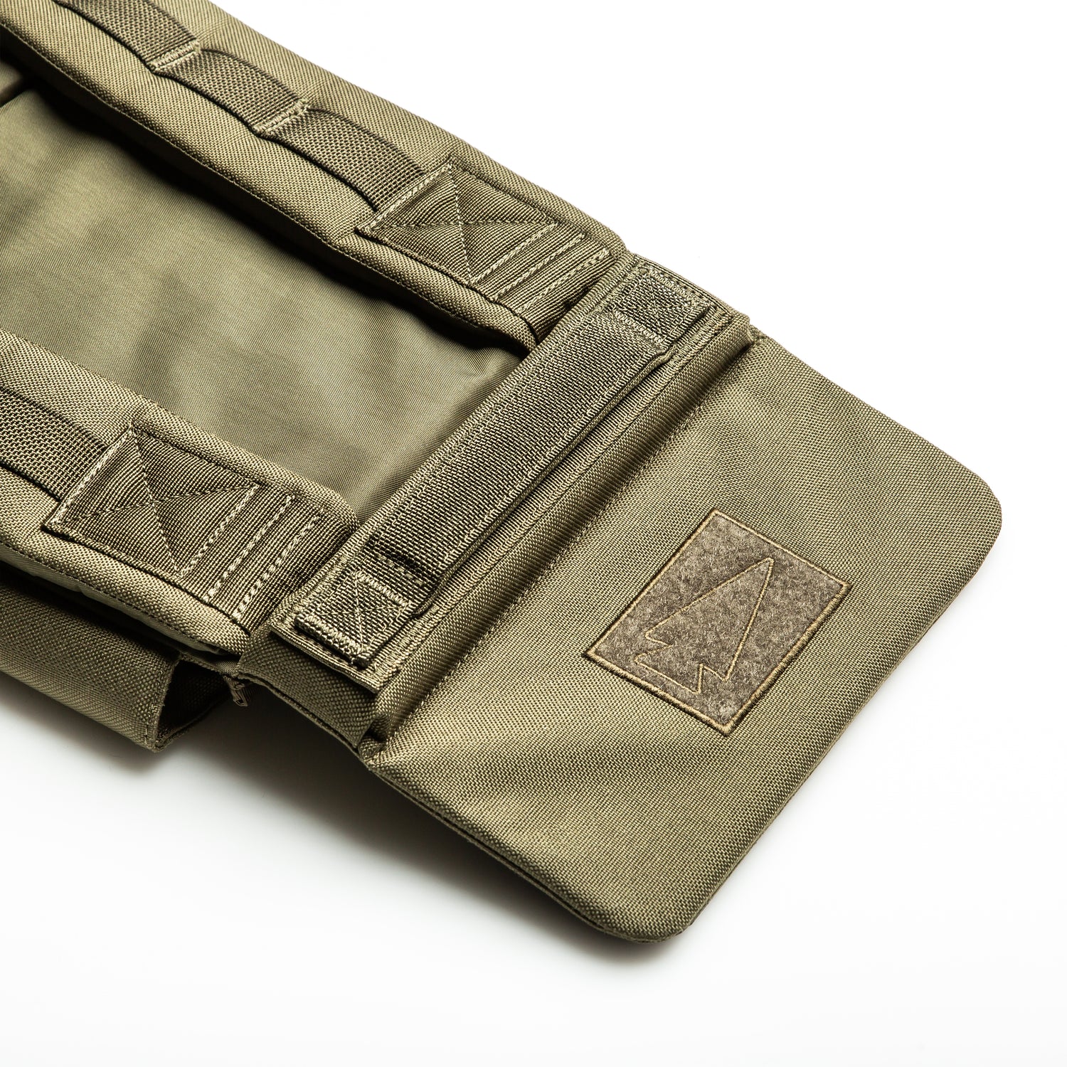 A close-up of the RPC 3.0 + 10lb Ruck Sandplate, featuring reinforced stitching and velcro patch on khaki fabric, designed for secure attachment to your training vest or Ruck Plate Carrier.