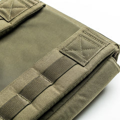 Close-up of the olive green RPC 3.0 backpack, made with reinforced stitching and heavy-duty fabric, shown folded and paired with a 10lb Ruck Sandplate—ideal for weighted training sessions.