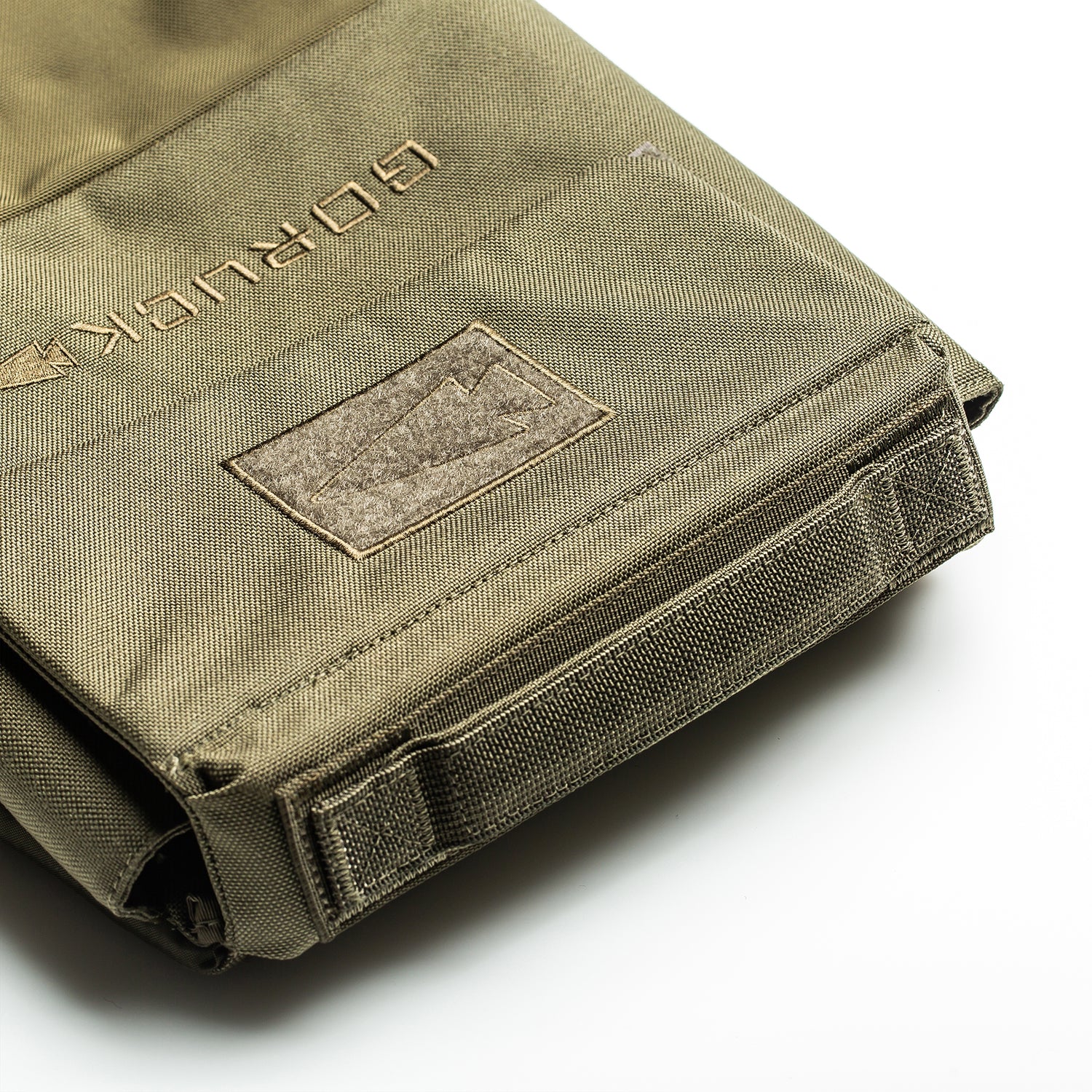 Close-up of an olive green RPC 3.0 + 10lb Ruck Sandplate bag with a stitched GORUCK patch, ideal for carrying your ruck plate or using as a Ruck Plate Carrier, shown on a white background.