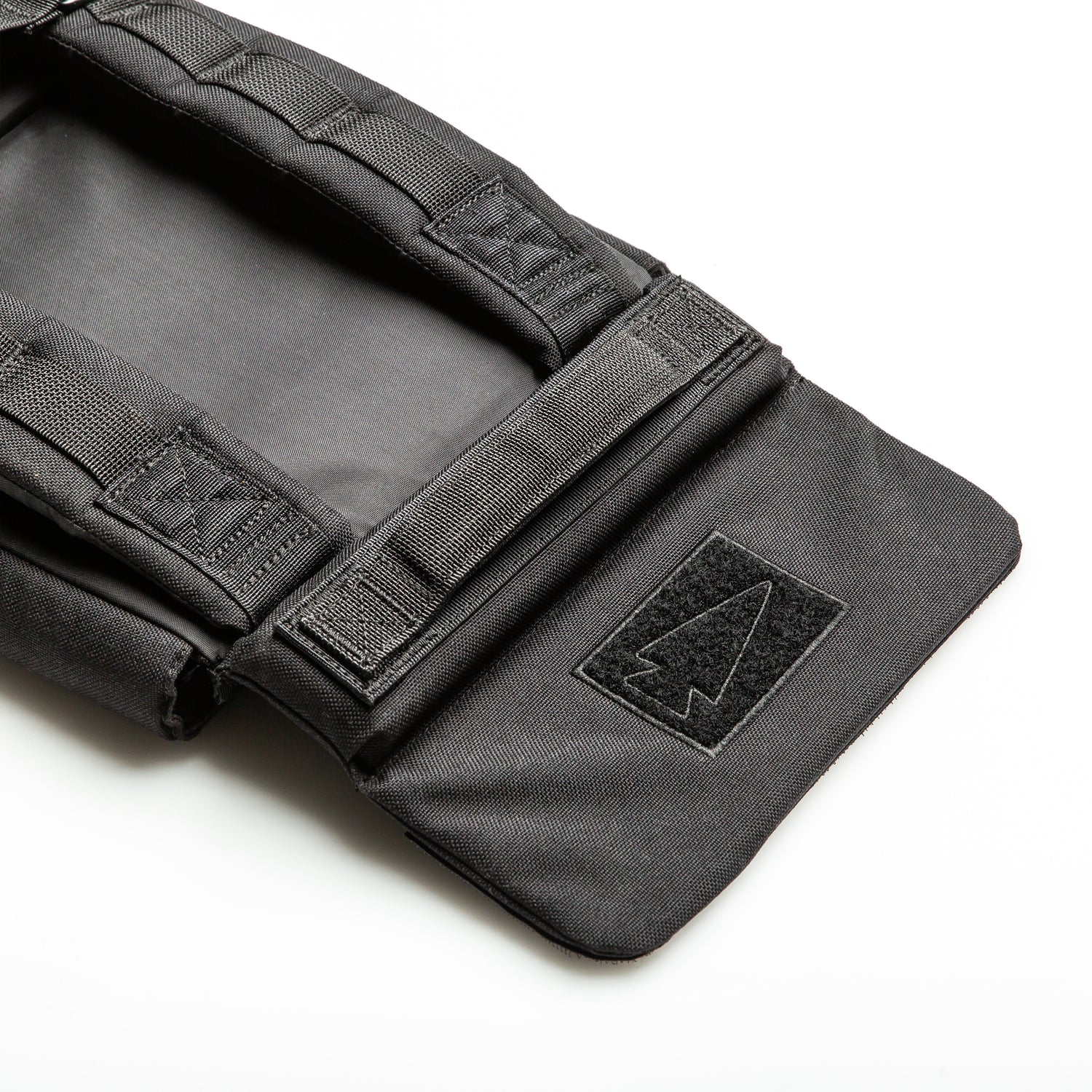 A close-up of the black RPC 3.0 + 10lb Ruck Sandplate, featuring a Velcro arrowhead patch and designed for secure plate holding during weighted training.