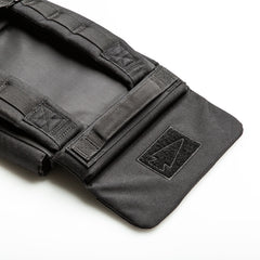 A close-up of the black RPC 3.0 + 10lb Ruck Sandplate, featuring a Velcro arrowhead patch and designed for secure plate holding during weighted training.