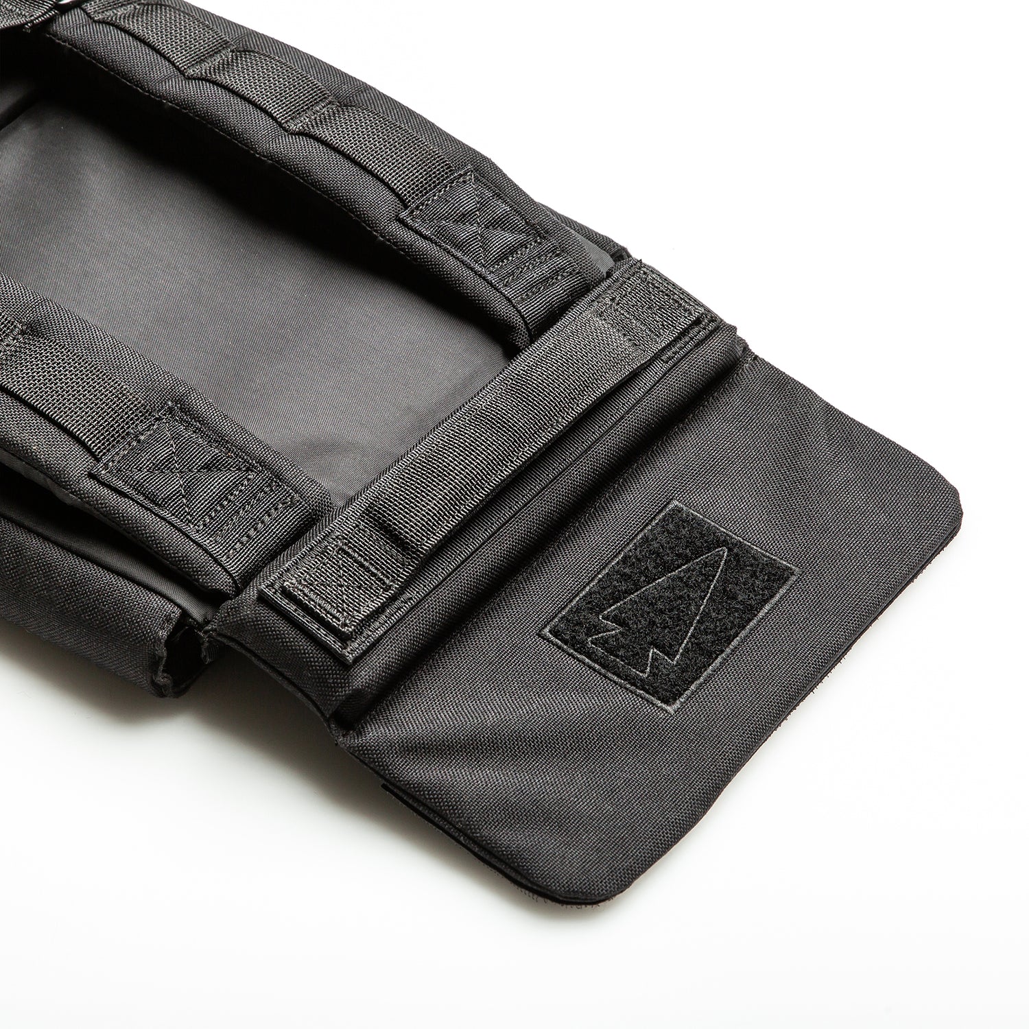 The RPC 3.0 + 10lb Ruck Sandplate is a black tactical backpack with an arrowhead patch, designed to hold a ruck plate for weighted training or use as a Ruck Plate Carrier.
