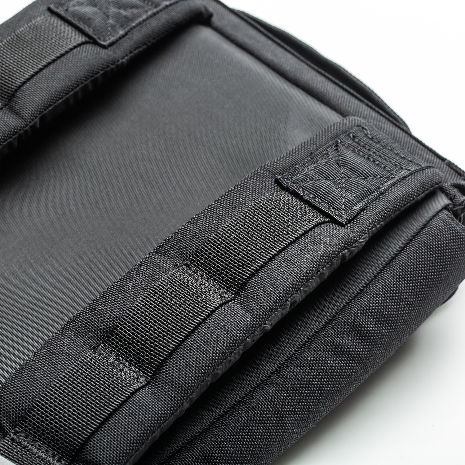 Close-up of the RPC 3.0 + 10lb Ruck Sandplate’s black padded backpack strap and stitching on a white background, designed for ruck plate compatibility—ideal for weighted training.