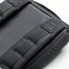 Close-up of the RPC 3.0 + 10lb Ruck Sandplate’s black padded backpack strap and stitching on a white background, designed for ruck plate compatibility—ideal for weighted training.