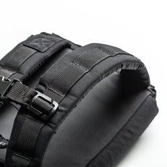 Close-up of black padded backpack straps with buckle on a white background, designed for weighted training with the RPC 3.0 + 10lb Ruck Sandplate.