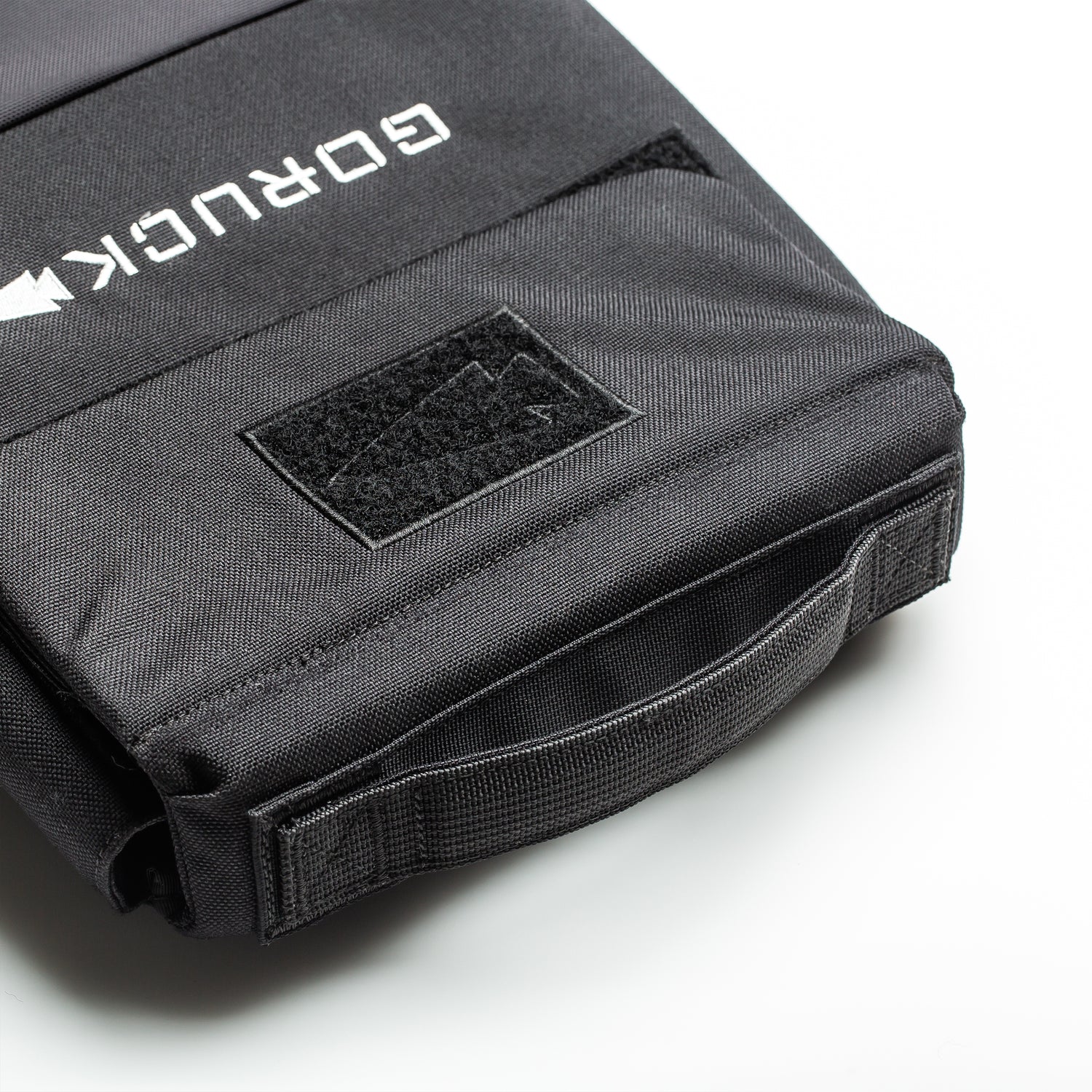 Close-up of a black RPC 3.0 + 10lb Ruck Sandplate backpack, highlighting the handle and front velcro patch area—ideal for weighted training with the included sandplate.