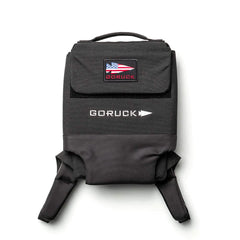 The Ruck Plate Carrier 3.0, a black backpack featuring ergonomic lumbar support and a U.S. flag patch on the flap, is photographed against a white background.