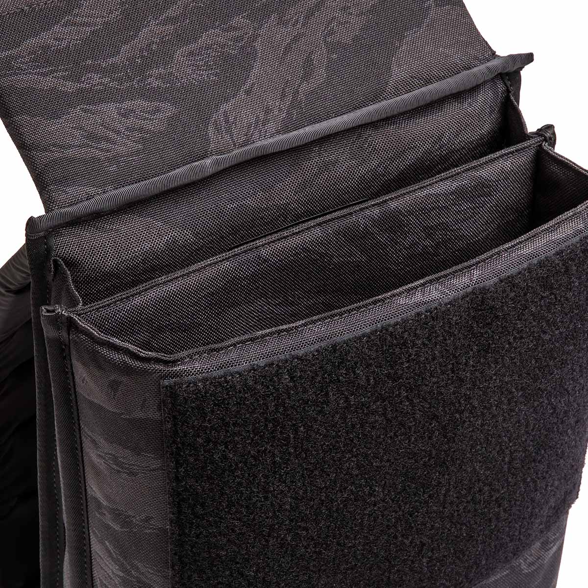 Close-up of the Ruck Plate Carrier 3.0, a black tactical pouch crafted from durable ballistic nylon with an open Velcro flap and internal compartments.