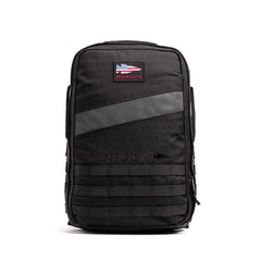 The Rucker 4.0 is a black rucksack with a GORUCK patch displaying the American flag and horizontal front straps, ideal for rucking or daily use.