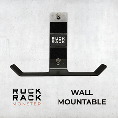 Ruck Rack® Monster—versatile wall-mount for rucks, weight vests, and tactical gear—displayed in black with bold “RUCK RACK” branding against a gray backdrop. Text reads “WALL MOUNTABLE.” The ultimate organizer for your American-made gear storage needs.