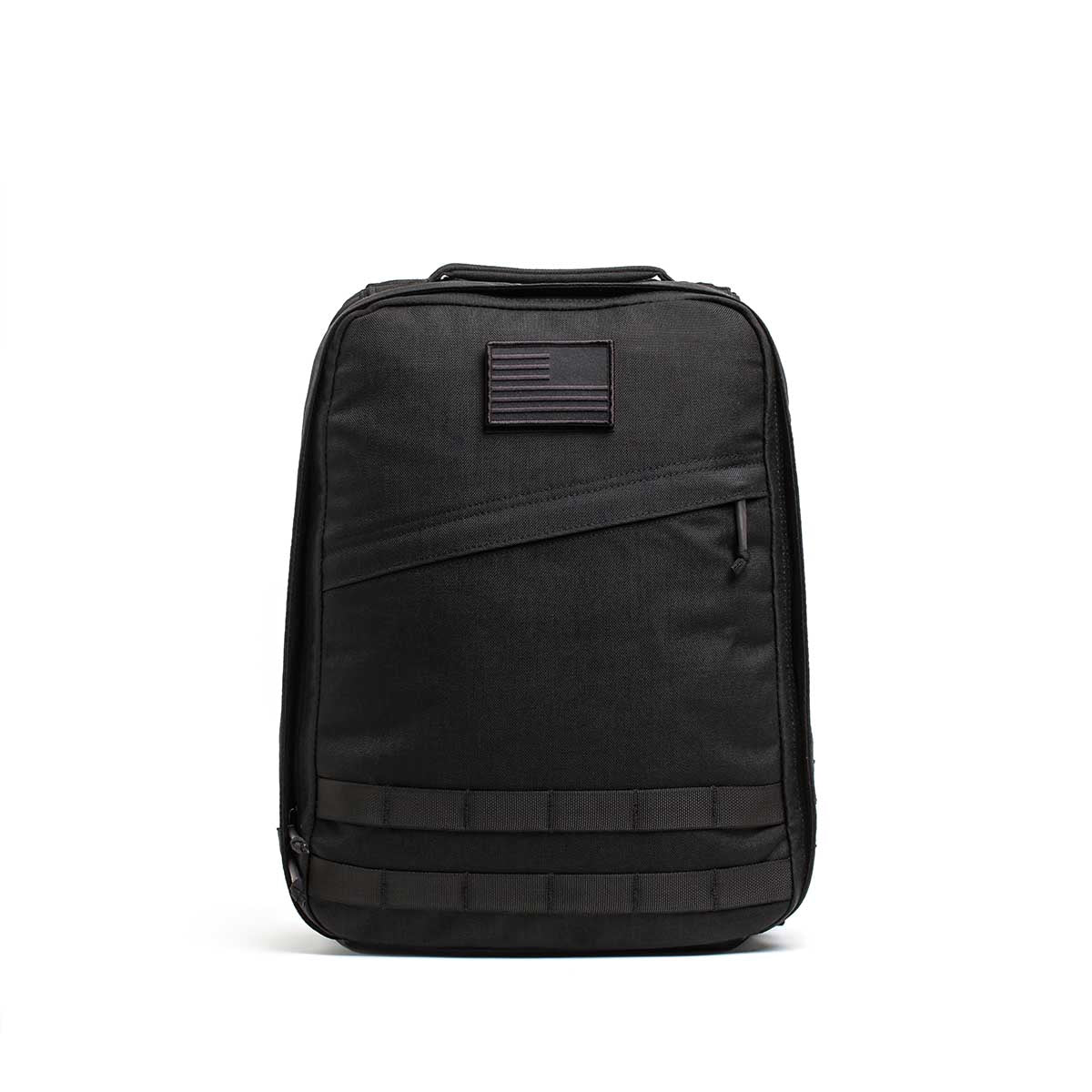 The Radio Ruck USA Throwback backpack features a muted American flag patch, front zipper pocket, horizontal webbing accents, and a bombproof laptop compartment inspired by Special Forces durability.