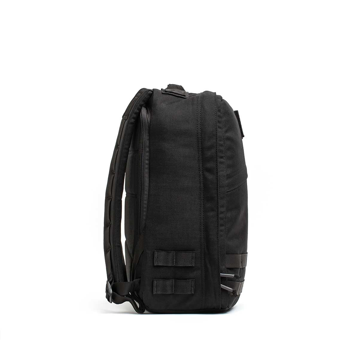 Radio Ruck USA Throwback backpack shown from the side, featuring padded straps, MOLLE-style webbing attachment points, and a bombproof laptop compartment for superior protection.