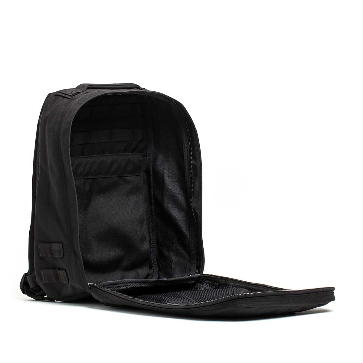 The Radio Ruck USA Throwback backpack, shown with its main compartment open, reveals interior pockets, a zippered mesh section, and a bombproof laptop compartment inspired by Special Forces durability.